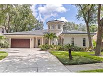 Stunning home with a turret entrance, lush landscaping, and a spacious two-car garage at 1936 Floresta View Dr, Tampa, FL 33618