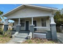Charming single-story home featuring a front porch and symmetrical design at 2219 Durham St, Tampa, FL 33605