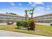Well-maintained condo complex with mature landscaping, signage, and convenient parking on a sunny day at 2261 Swedish Dr # 47, Clearwater, FL 33763