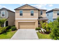Inviting two-story home showcasing a well-maintained lawn and an attached two-car garage at 4403 Eternal Prince, Sun City Center, FL 33573