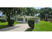 Charming single-story home featuring a well-maintained yard and a welcoming entrance at 4754 17Th St, Zephyrhills, FL 33542