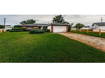 Charming home with lush green lawn, brick-lined driveway, and a well-manicured landscape at 5919 35Th N Ave, St Petersburg, FL 33703