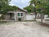 Charming single-story home exterior with neutral paint and simple landscaping in a sunny locale at 7806 N Orleans Ave, Tampa, FL 33604