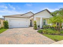Charming one-story home features a two-car garage, brick driveway, and professionally landscaped yard at 8460 Capstone Ranch Dr, New Port Richey, FL 34655