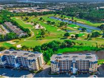 Beautiful aerial view of condos overlooking a meticulously manicured golf course and tranquil waterways at 960 Starkey Rd # 9104, Largo, FL 33771