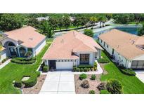 Charming single-story home featuring a two-car garage, manicured landscaping, and inviting curb appeal at 11121 Cherrywood Ct, Spring Hill, FL 34609