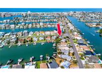 Aerial view of waterfront property with access to the Gulf, featuring a canal and nearby community at 11465 7Th E St, Treasure Island, FL 33706