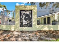 Exterior community sign for Art Center Lofts in St. Petersburg, Florida, featuring unique design and gated fence at 1501 Doyle Carlton Dr # 303, Tampa, FL 33602
