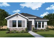 Charming single-story home with stone accents, gray shutters, and well-manicured landscaping at 316 Vistera Blvd, Nokomis, FL 34275