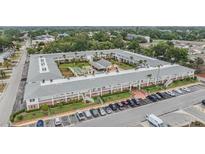 An aerial view of the condominium building with a pool and parking at 4748 Azalea Dr # 204, New Port Richey, FL 34652