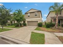 Charming two-story home with a well-maintained lawn and driveway at 6961 King Creek Dr, Sun City Center, FL 33573