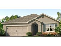 Charming one-story home featuring a neutral color scheme and an attached two-car garage at 7696 Wheat Stone Dr, Zephyrhills, FL 33540