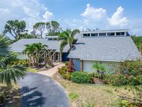 Stunning home featuring beautiful landscaping, a brick walkway, and a striking blue double door entry at 7815 16Th Nw Ave, Bradenton, FL 34209