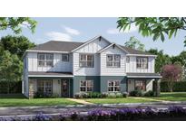 Charming two-story duplex with stone accents, white siding, and well-maintained landscaping at 10705 Wading River Ave, Parrish, FL 34219