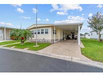 Charming manufactured home with a well-manicured lawn and a covered parking area, perfect for a relaxed lifestyle at 12501 Ulmerton Rd # 110, Largo, FL 33774
