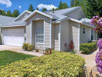 Inviting single-Gathering home features charming landscaping and an attached garage at 1605 Send Way, Lutz, FL 33549