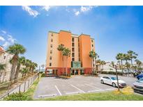 Charming multi-story building with palm trees and a parking lot in a sunny coastal setting at 17334 Gulf Blvd # 203, North Redington Beach, FL 33708