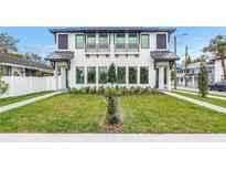 Striking modern two-story home featuring black window accents and a meticulously manicured front yard at 2812 N Massachusetts Ave, Tampa, FL 33602