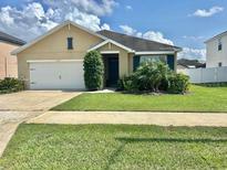 Charming single-story home with a well-maintained lawn, beautiful landscaping, and a two-car garage at 3313 San Moise Pl, Plant City, FL 33567