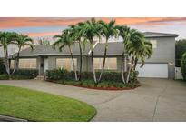 Charming single Gathering home featuring a neatly manicured lawn, lush landscaping, and a two car garage at 333 30Th N Ave, St Petersburg, FL 33704
