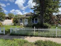 Charming home featuring a quaint picket fence and a well-maintained lawn at 341 20Th S Ave, St Petersburg, FL 33705