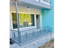 Inviting front porch with a wind chime, decorative railing, and large window that brightens the entrance at 4020 55Th N St # 1106, Kenneth City, FL 33709