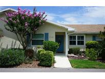 Charming home exterior featuring a well-maintained lawn, vibrant landscaping, and inviting front entrance at 413 Lake Point Ct # 4B, Sun City Center, FL 33573