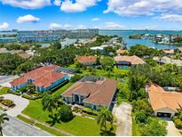 Waterfront homes boast private pools and lush landscaping in a desirable community close to the bay at 5904 Pelican Bay S Plz, Gulfport, FL 33707
