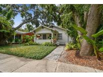 Charming bungalow featuring mature landscaping, covered front porch, and inviting curb appeal at 848 9Th S Ave, St Petersburg, FL 33701