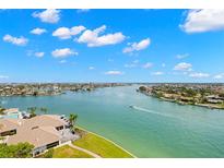 Stunning aerial view of the waterfront property featuring a serene pool and lush green landscaping at 9425 Blind Pass Rd # 1008, St Pete Beach, FL 33706