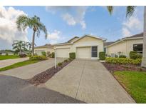 Charming home featuring a two-car garage, well-manicured landscaping, and a welcoming entrance at 1012 Radison Lake Ct # 59, Sun City Center, FL 33573