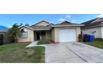 Charming single Gathering home with attached garage and well-manicured front lawn at 12804 Millridge Forest St, Tampa, FL 33624