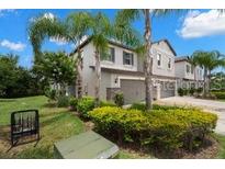Attractive two-story home featuring manicured landscaping, multi-car garage, and neutral paint at 1395 White Fox Run, Lutz, FL 33549
