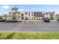 Well-maintained condo building with covered parking and mature landscaping at 213 Fernwood Cir # 213, Seminole, FL 33777