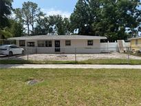 Charming single-story home with mature trees and a fenced yard, offering both privacy and curb appeal at 4422 W Wisconsin Ave, Tampa, FL 33616