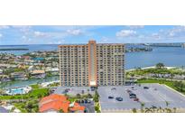 High-rise condo building showcases amazing water views, a parking lot, and lush landscaping at 4900 Brittany S Dr # 611, St Petersburg, FL 33715