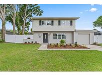 Charming two-story home with a well-manicured lawn and welcoming front entrance at 4918 Stolls Ave, Tampa, FL 33615