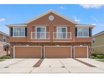 Inviting townhome with a three car garage, stone accents, balconies, and beautifully painted exterior at 589 52Nd N Ave, St Petersburg, FL 33703