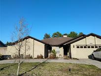 Charming single-story home with a well-maintained front yard, driveway, and two car garage at 6645 Freeport Dr, Spring Hill, FL 34608