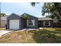 Charming single-story home featuring a well-maintained lawn and attached one car garage at 6817 S Gabrielle St, Tampa, FL 33611