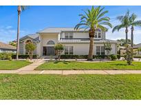 Stunning two-story home boasts lush landscaping, a manicured lawn, and a striking gray roof at 7114 Pelican Island Dr, Tampa, FL 33634