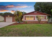Charming single-story home featuring a well-maintained lawn and colorful landscaping at 7276 21St Street N, St Petersburg, FL 33702