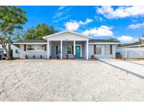 Charming single-story home with a bright blue front door and newly landscaped gravel front yard at 7804 Bracken Dr, Port Richey, FL 34668