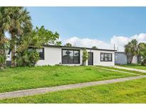 Charming single-story home with a well-manicured lawn and tropical palm trees, perfect for Florida living at 7930 Jeffery Ave, North Port, FL 34287