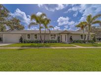 Charming single-story home featuring a manicured lawn and inviting front entrance with bright neutral paint scheme at 102 7Th Se Ave, Largo, FL 33771