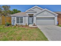 Charming single-Gathering home featuring a well-maintained front yard and attached two-car garage at 10414 Hallmark Blvd, Riverview, FL 33578