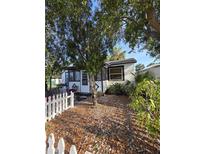 Charming home with a picket fence and landscaping in the front yard at 1107 Grant St, Clearwater, FL 33755