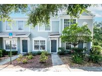 Inviting townhome showcasing a well-maintained facade and lovely landscaped front yard at 2316 Lake Woodberry Cir, Brandon, FL 33510