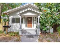 Charming home featuring a wood front door with glass panes and gray brick pillars at the entrance at 2808 N Highland Ave, Tampa, FL 33602