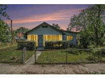 Charming bungalow featuring a cozy enclosed porch and well-maintained front yard at 3008 E Wilder Ave, Tampa, FL 33610